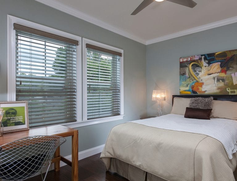 Wood blinds in a bedroom. Faux Wood Blinds