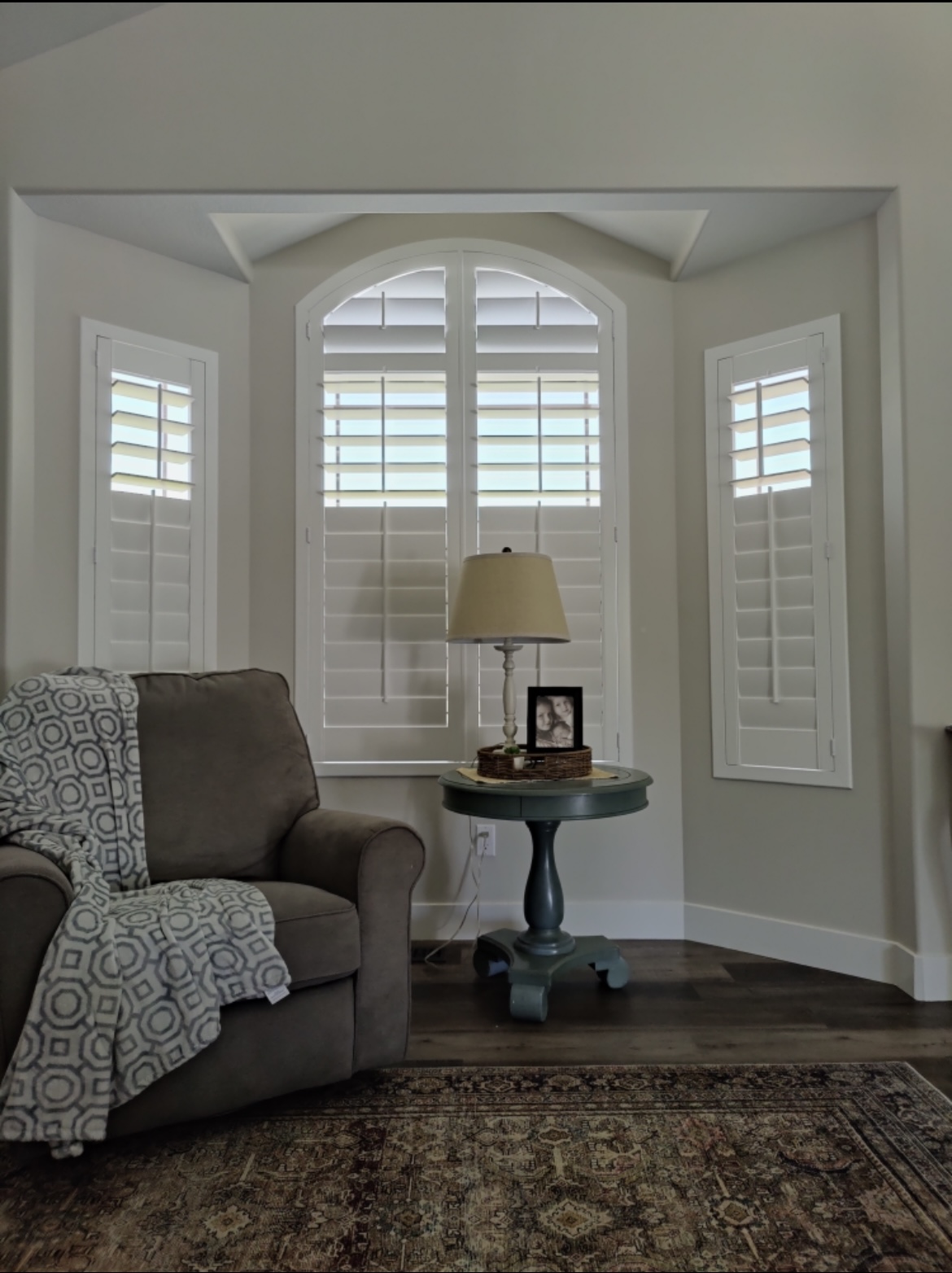 Traditional White shutters with an arch in sitting room